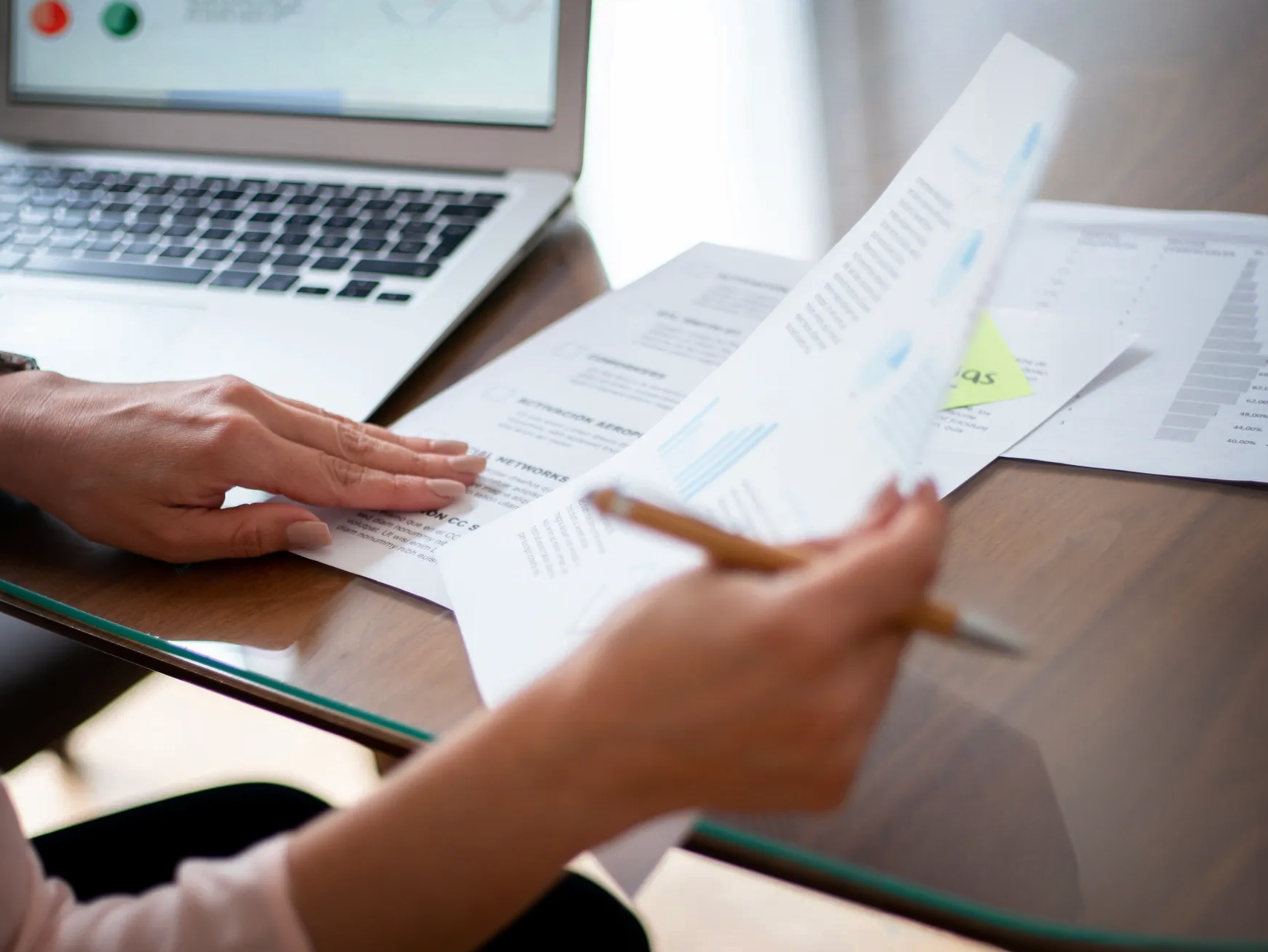 Reviewing business documents and reports at a desk, illustrating GDPR compliance and data governance support